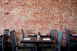 restaurant table setting with brick wall backdrop